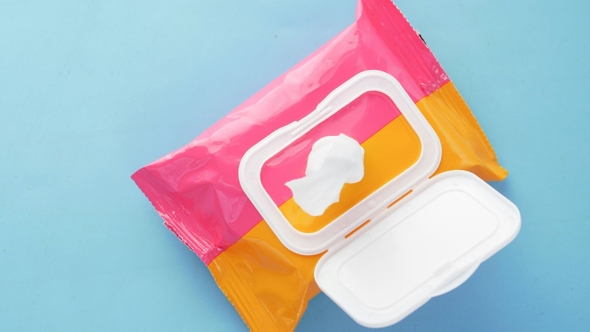 a pink and yellow bag of food on a blue surface