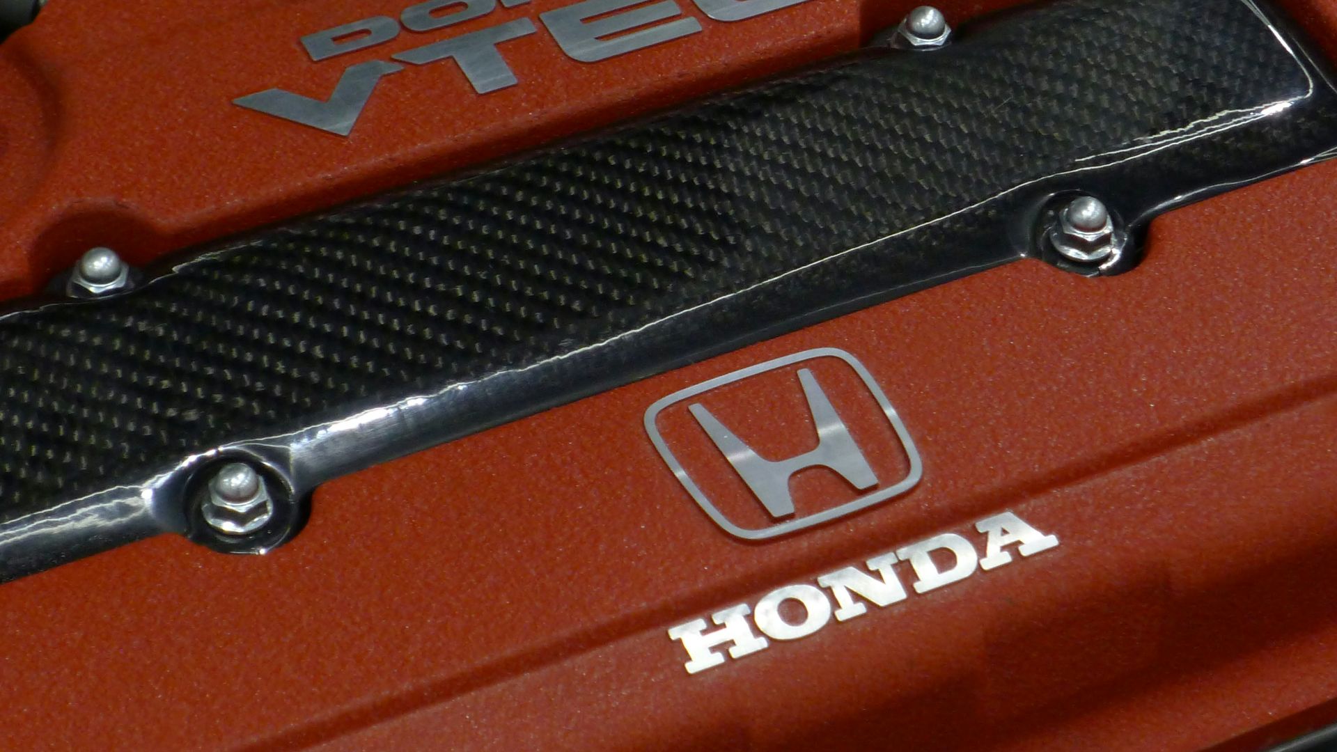 a close up of the hood of a red car