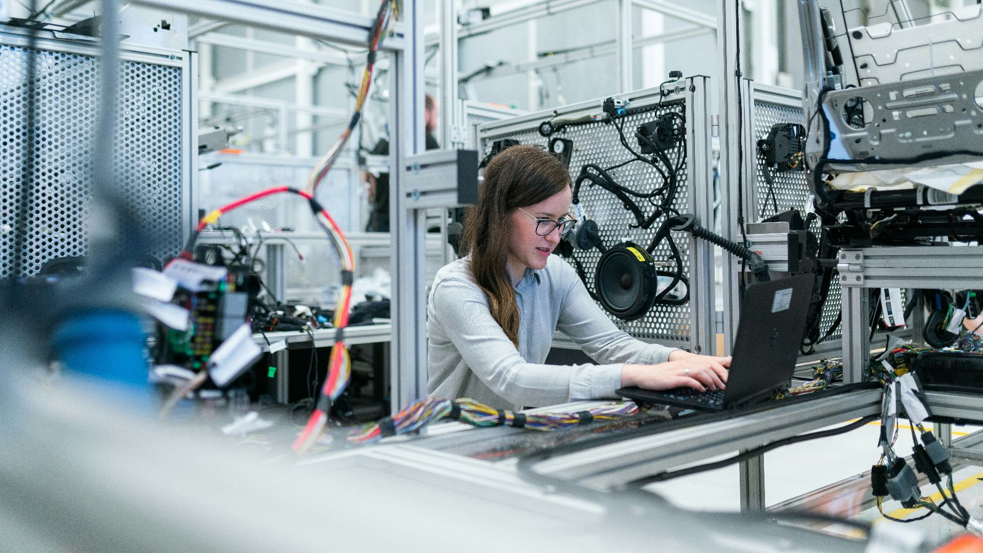 woman in white long sleeve shirt using black laptop computer