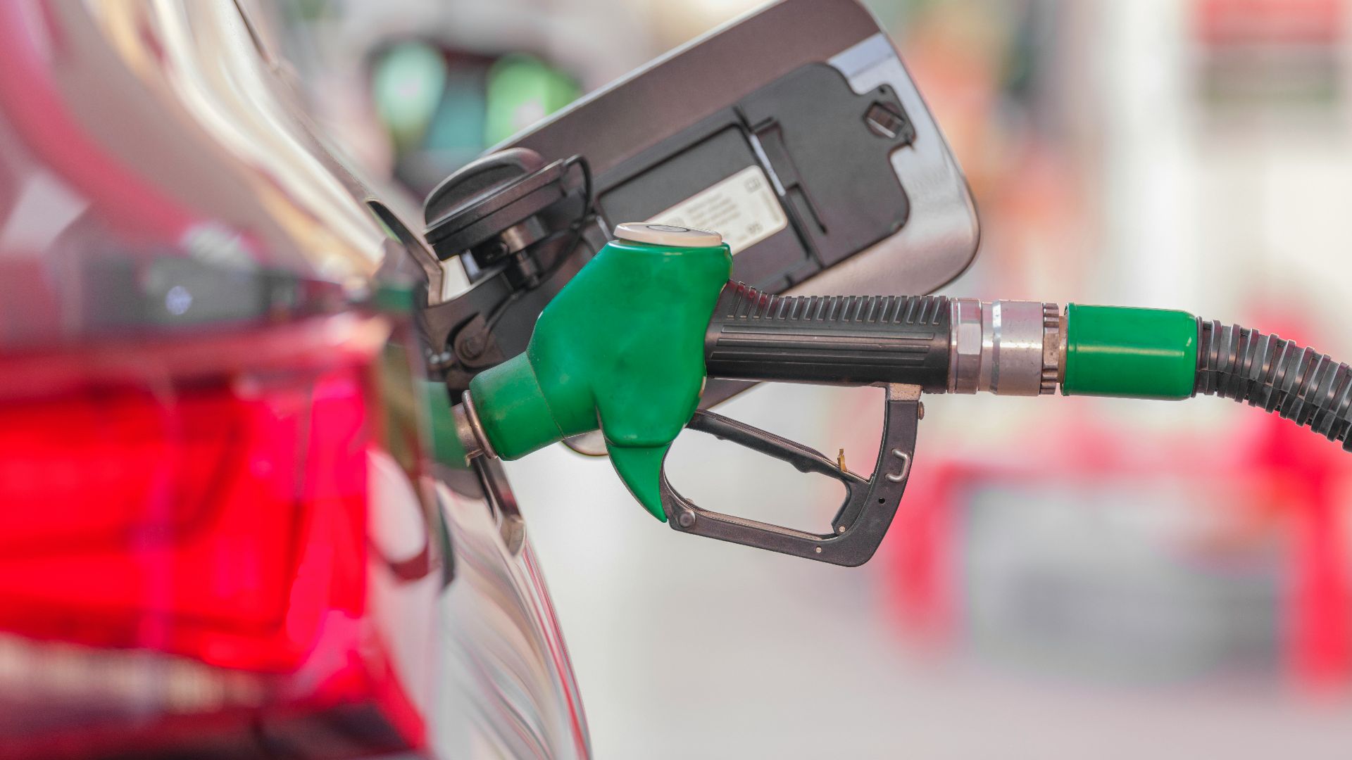 a gas pump is connected to a car at a gas station