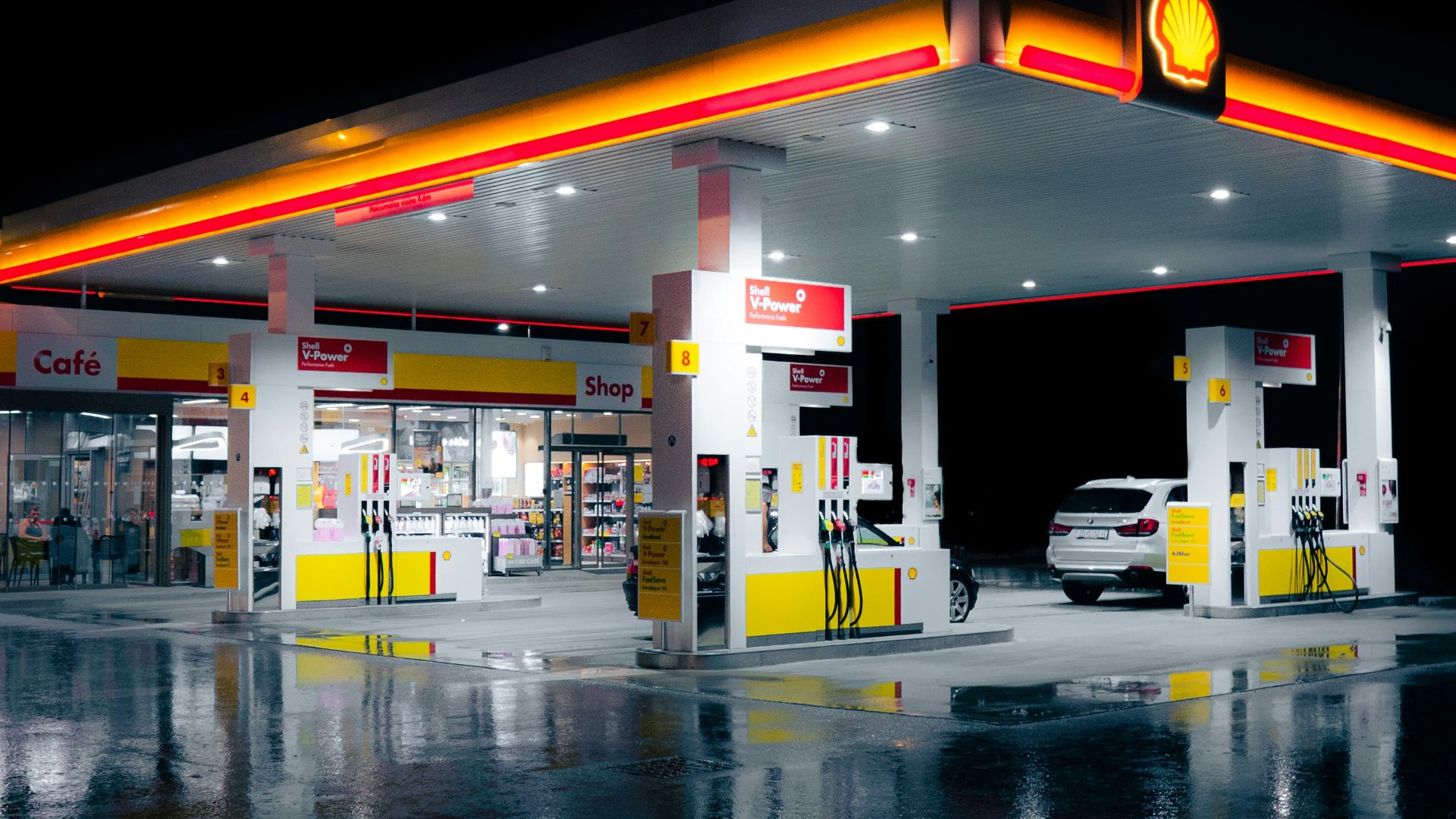 a gas station lit up at night time