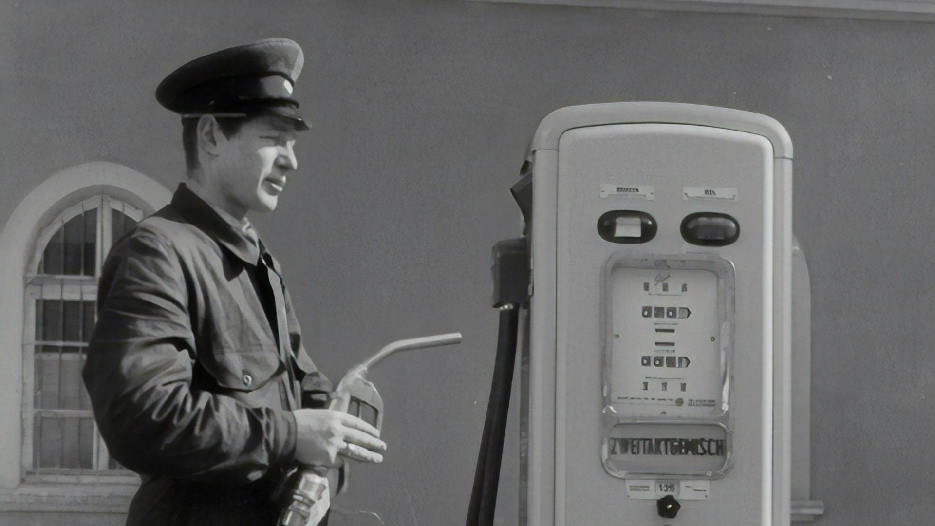 man in black coat holding microphone