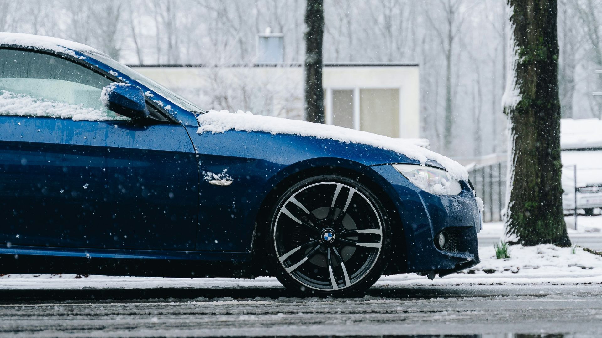 a blue sports car parked on the side of the road