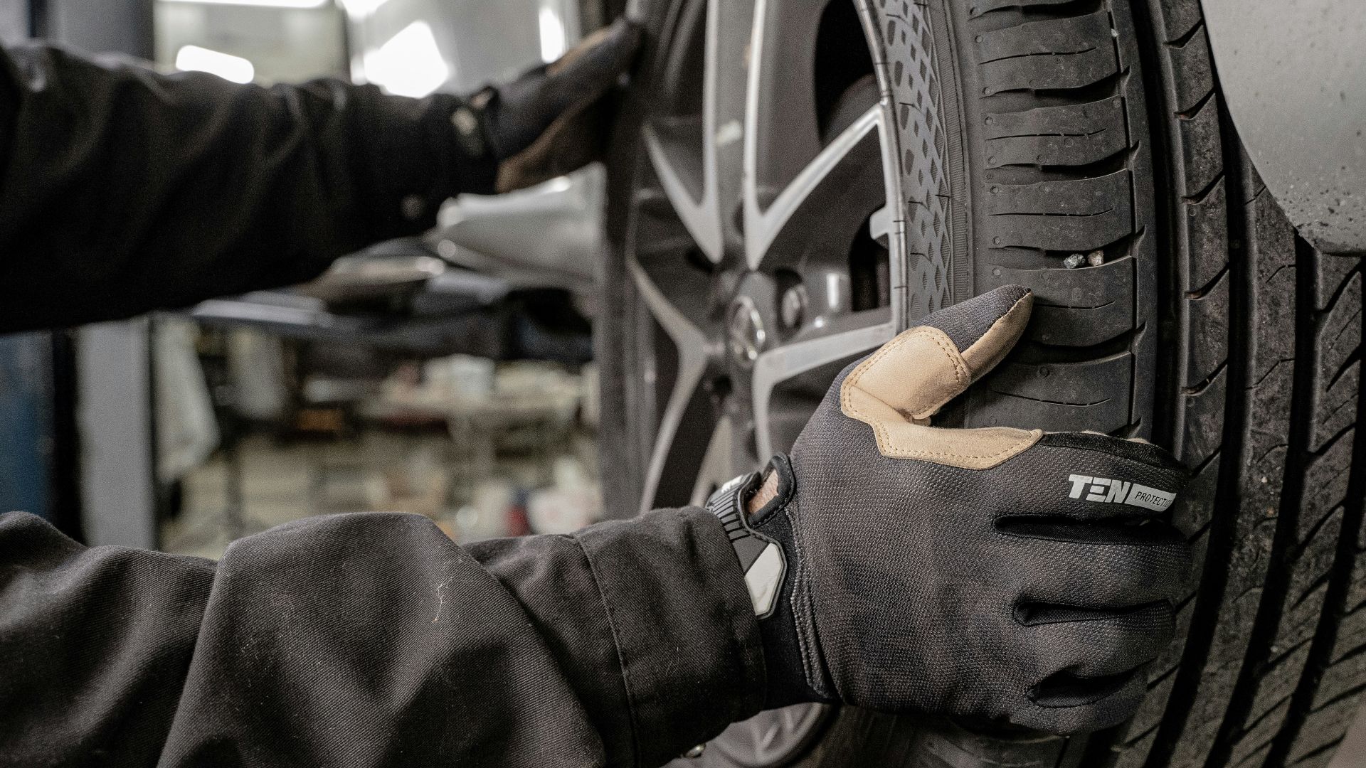 a man working on a tire in a garage
