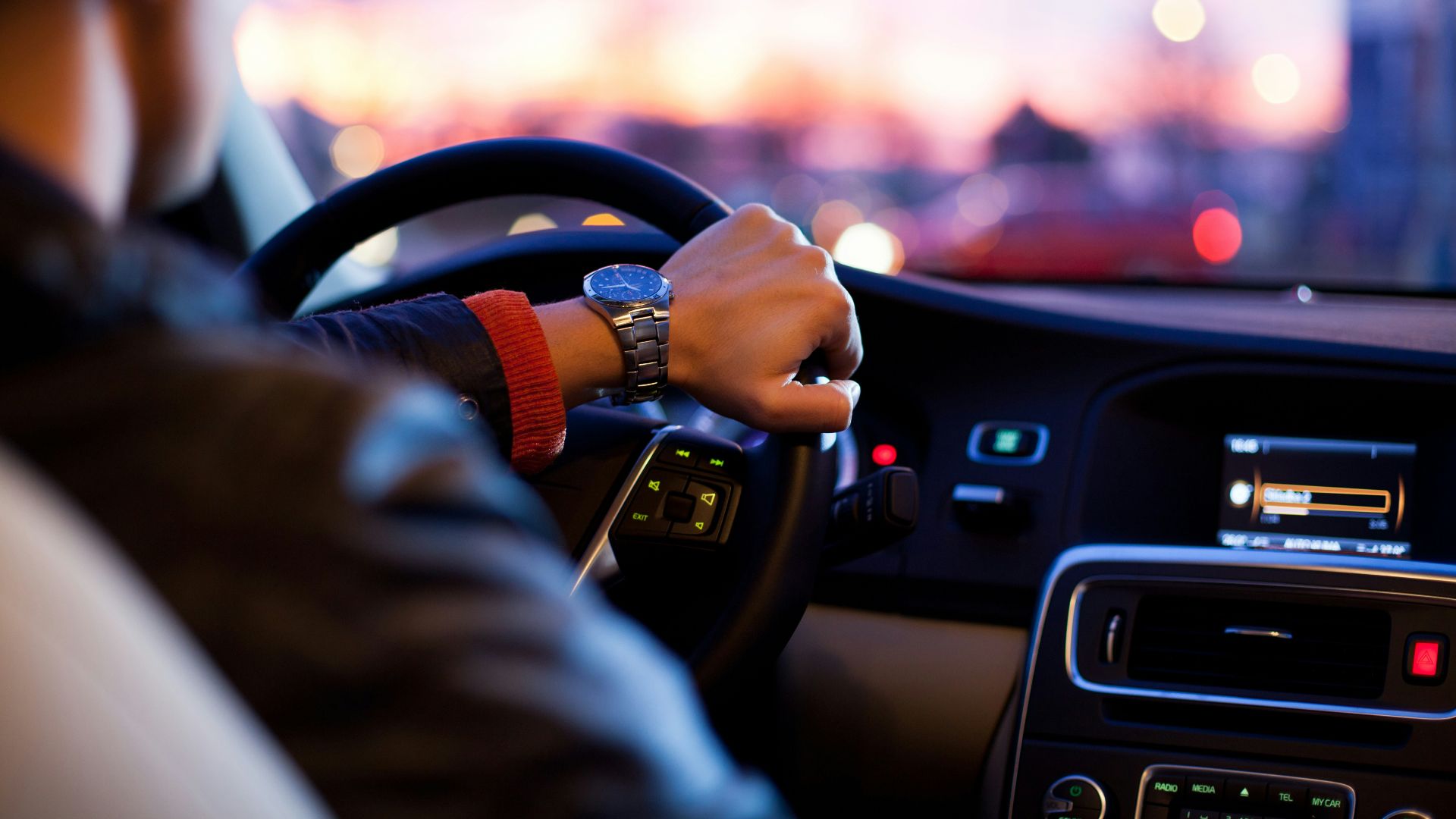 man driving a car wearing wrist watch
