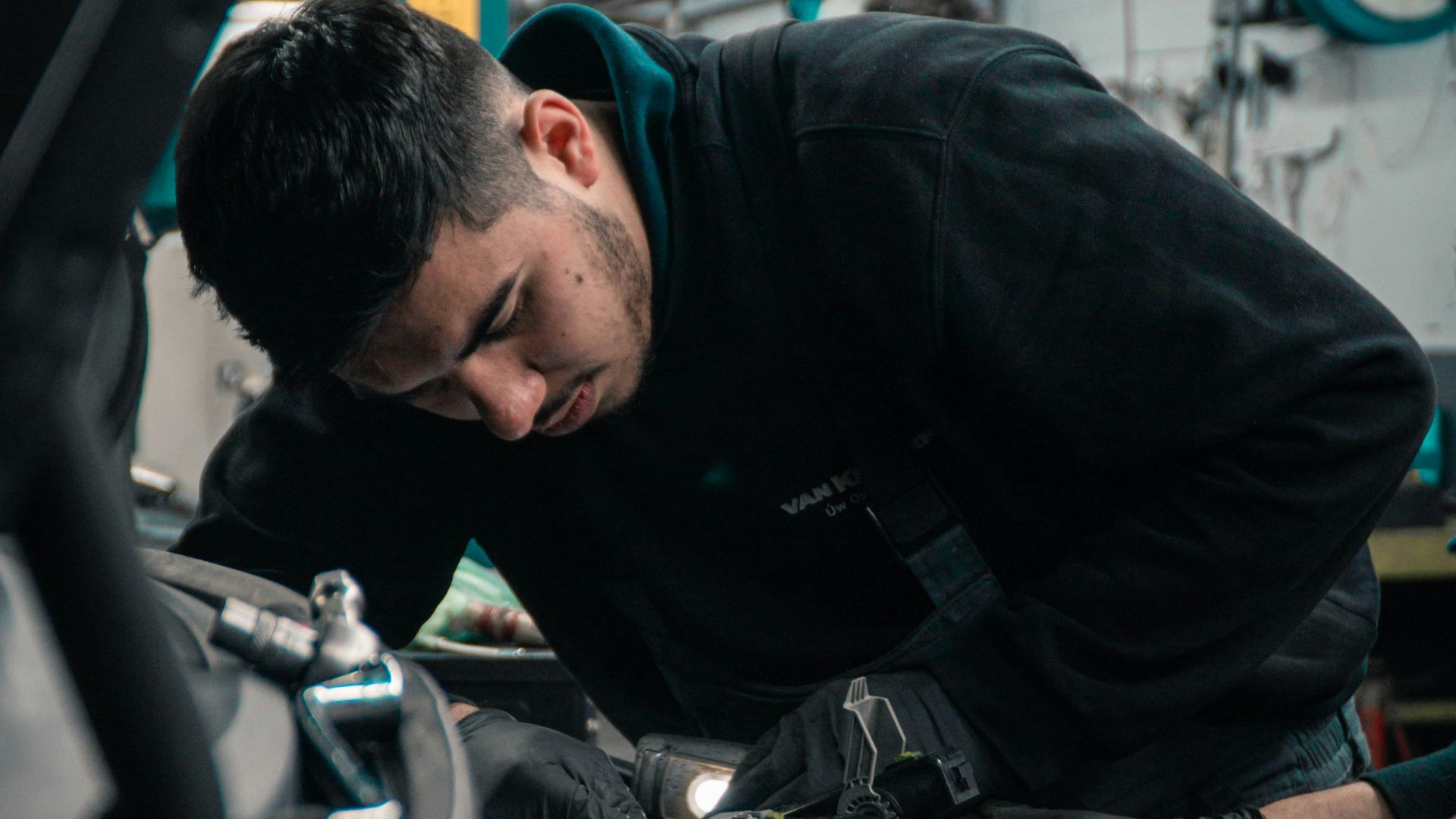 man in black jacket and blue denim jeans riding motorcycle