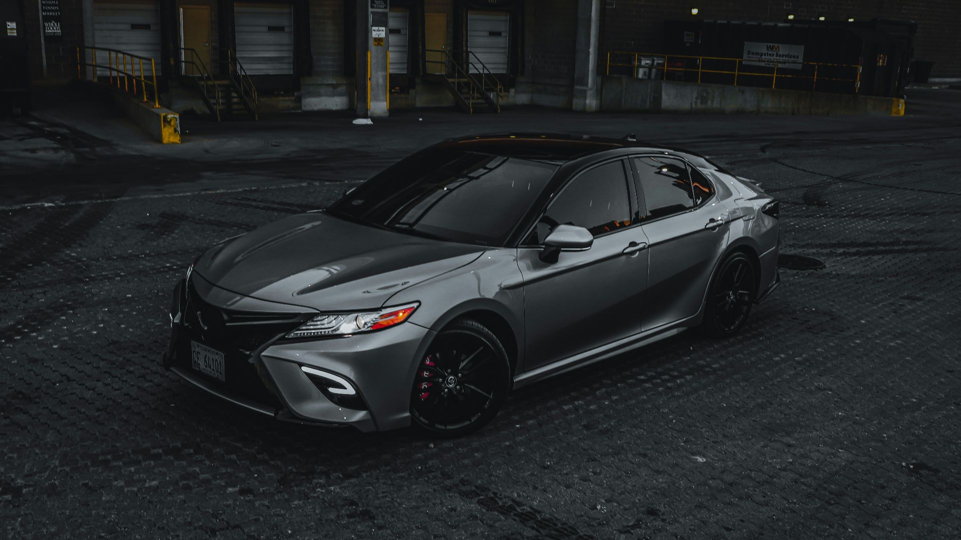 silver sedan parked on road during daytime
