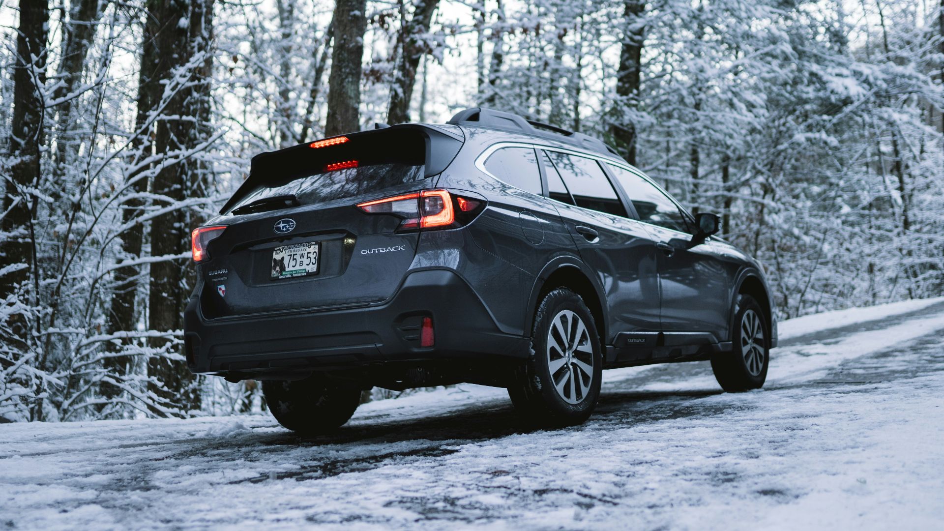 black suv on snow covered ground during daytime