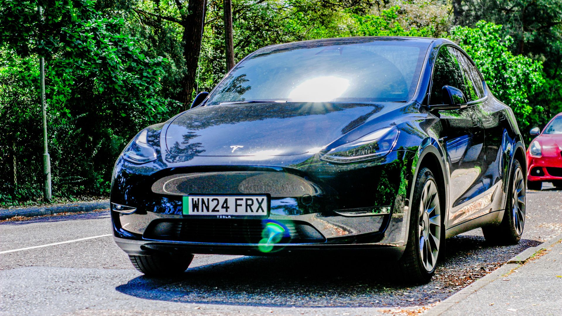 Two cars are parked on the side of the road