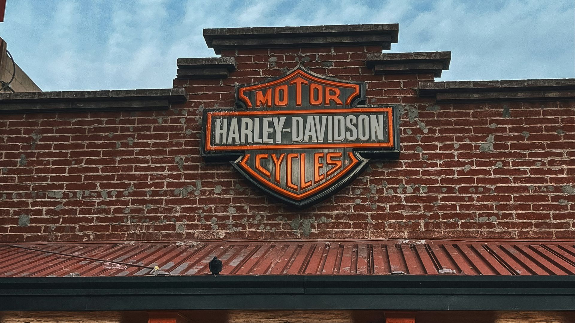 a brick building with a sign that says harley davidson cycles