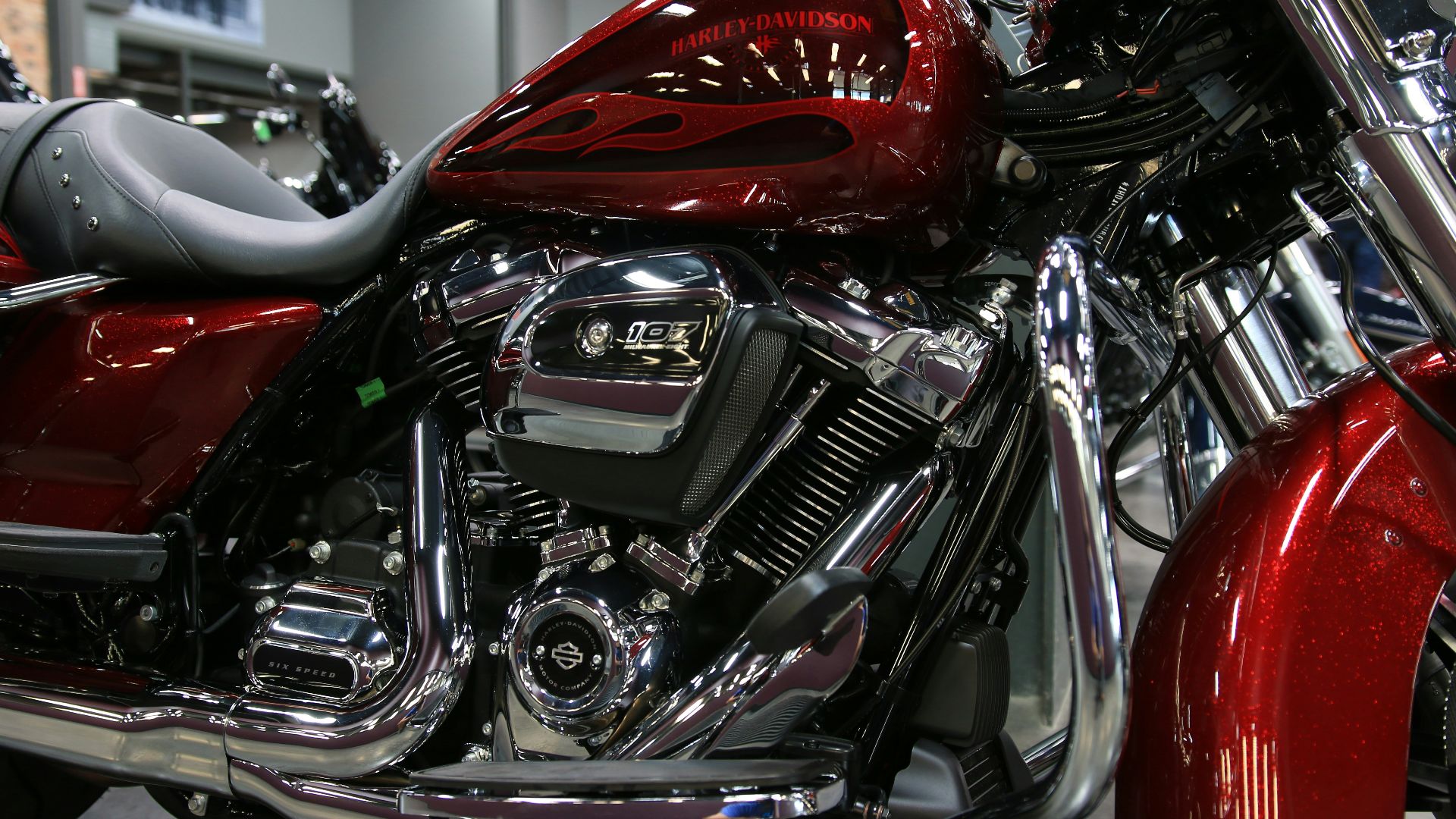 a red motorcycle is parked in a showroom