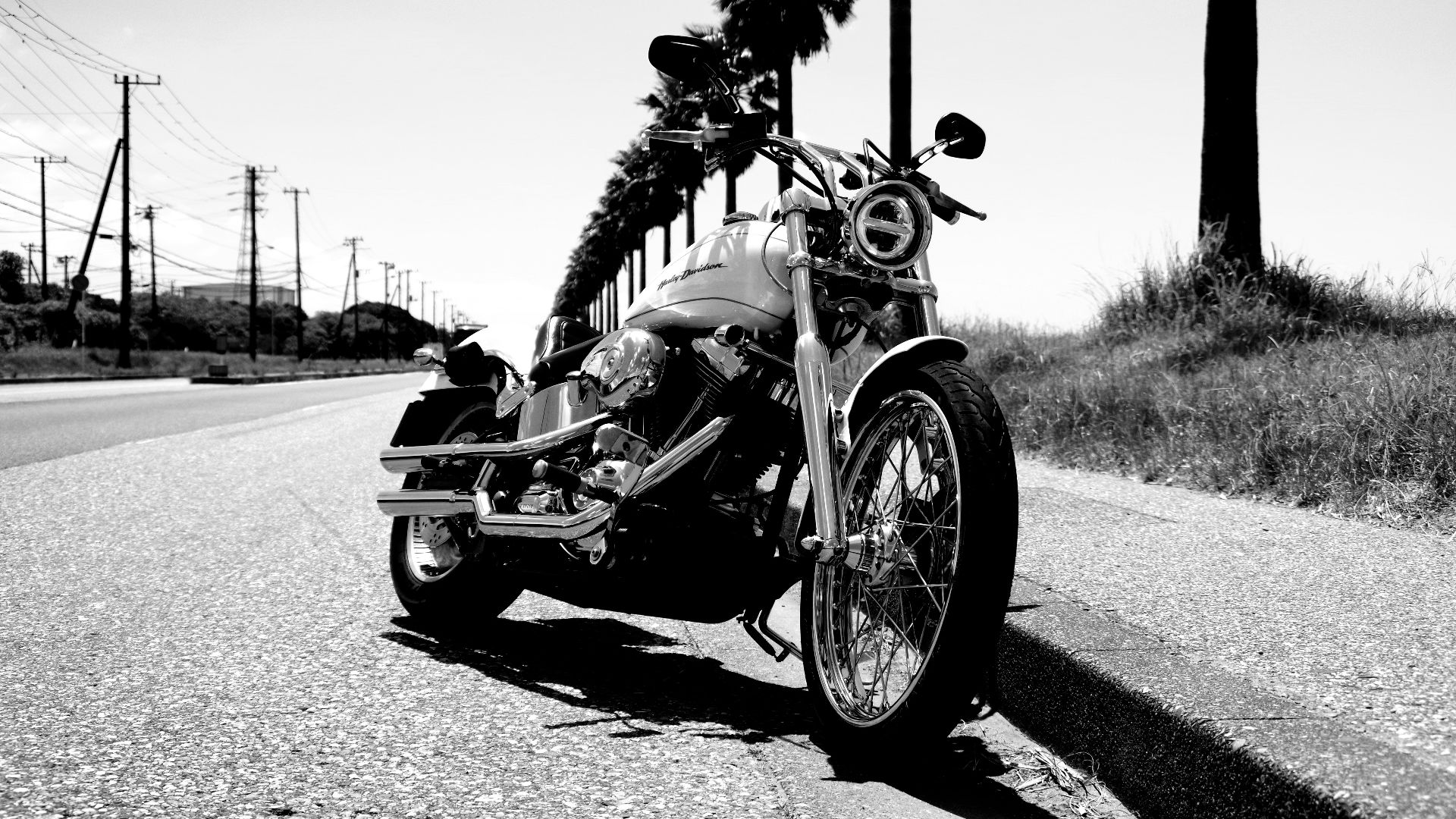 grayscale photo of motorcycle parked on road