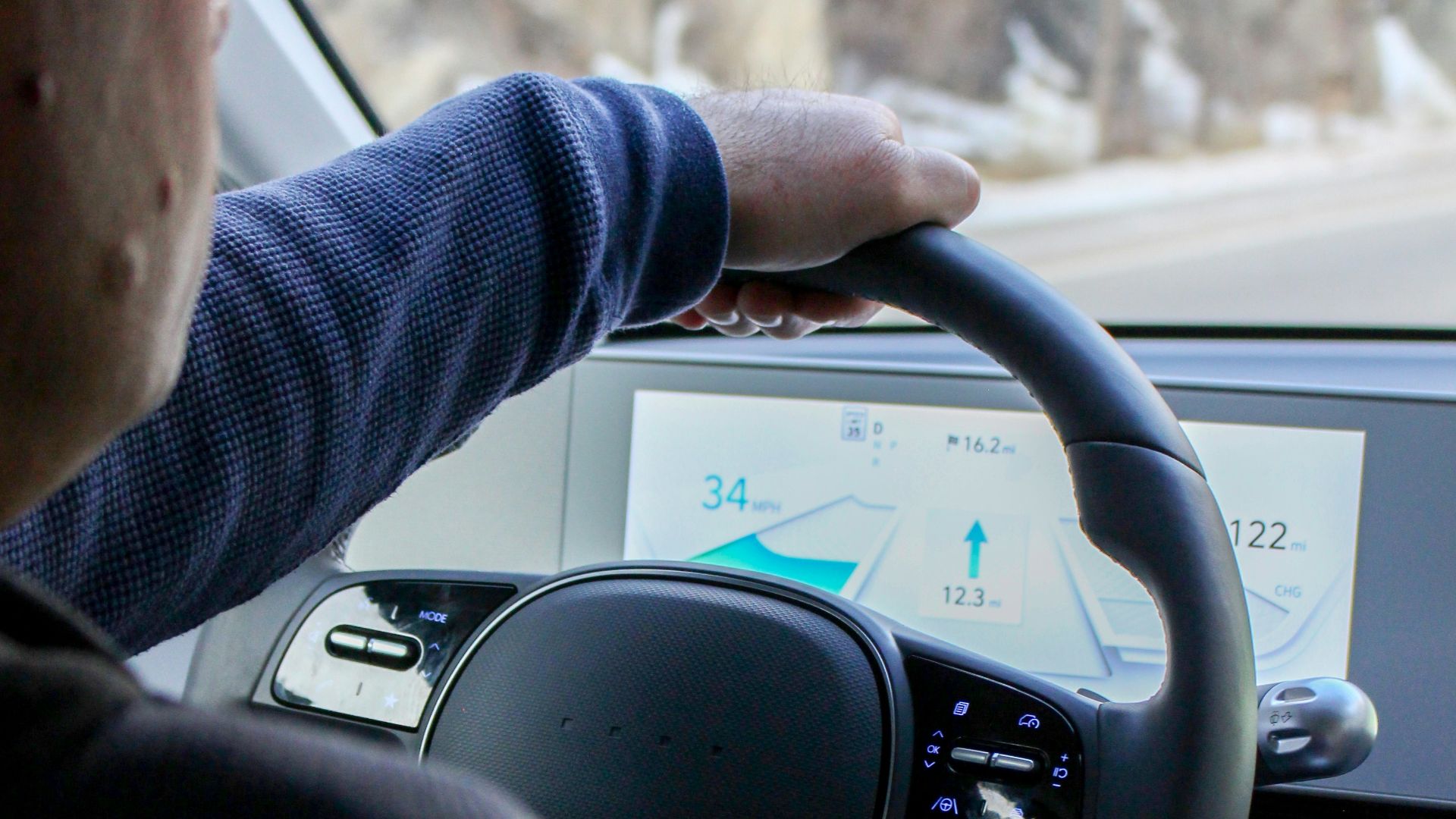 a man driving a car on a snowy road