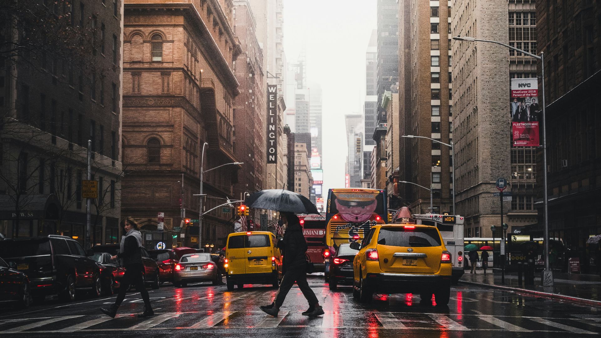 person walking on pedestrian lane between buildings