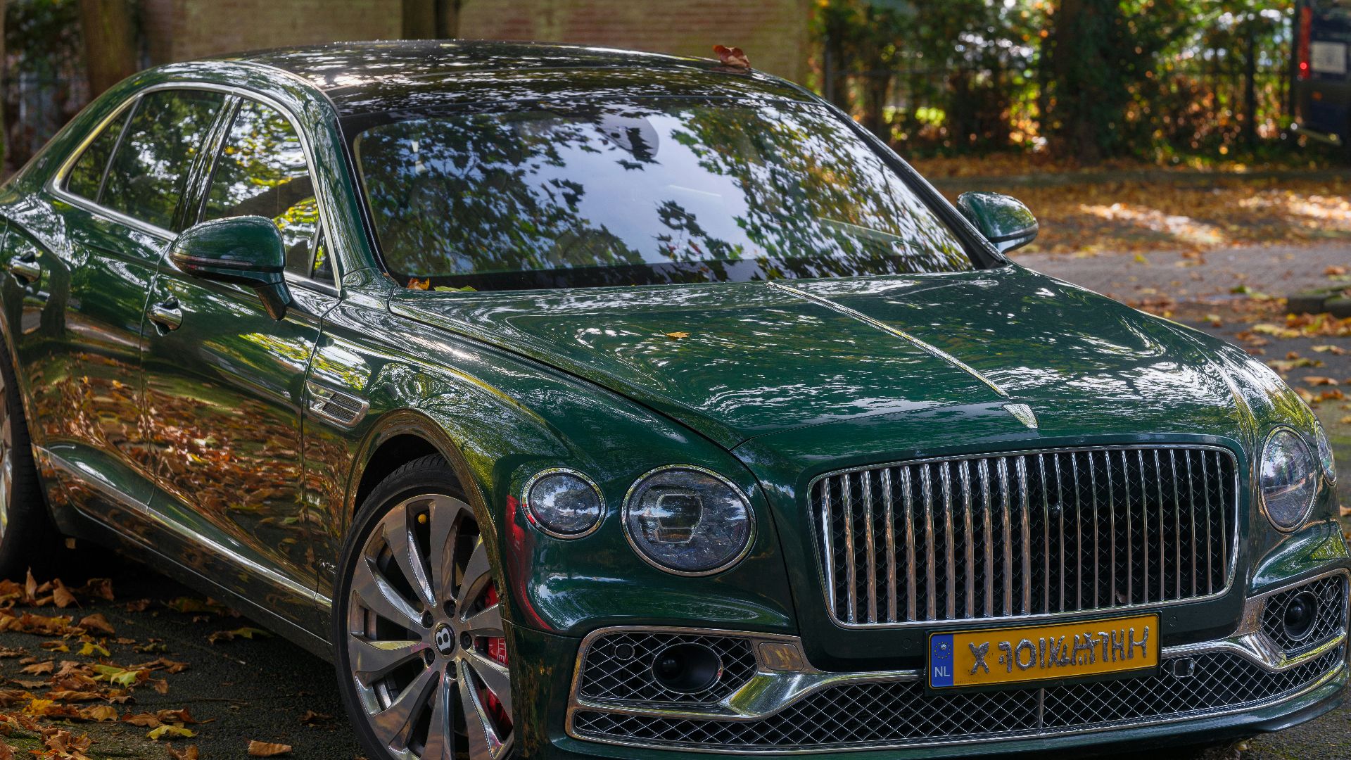 A green car parked on the side of the road