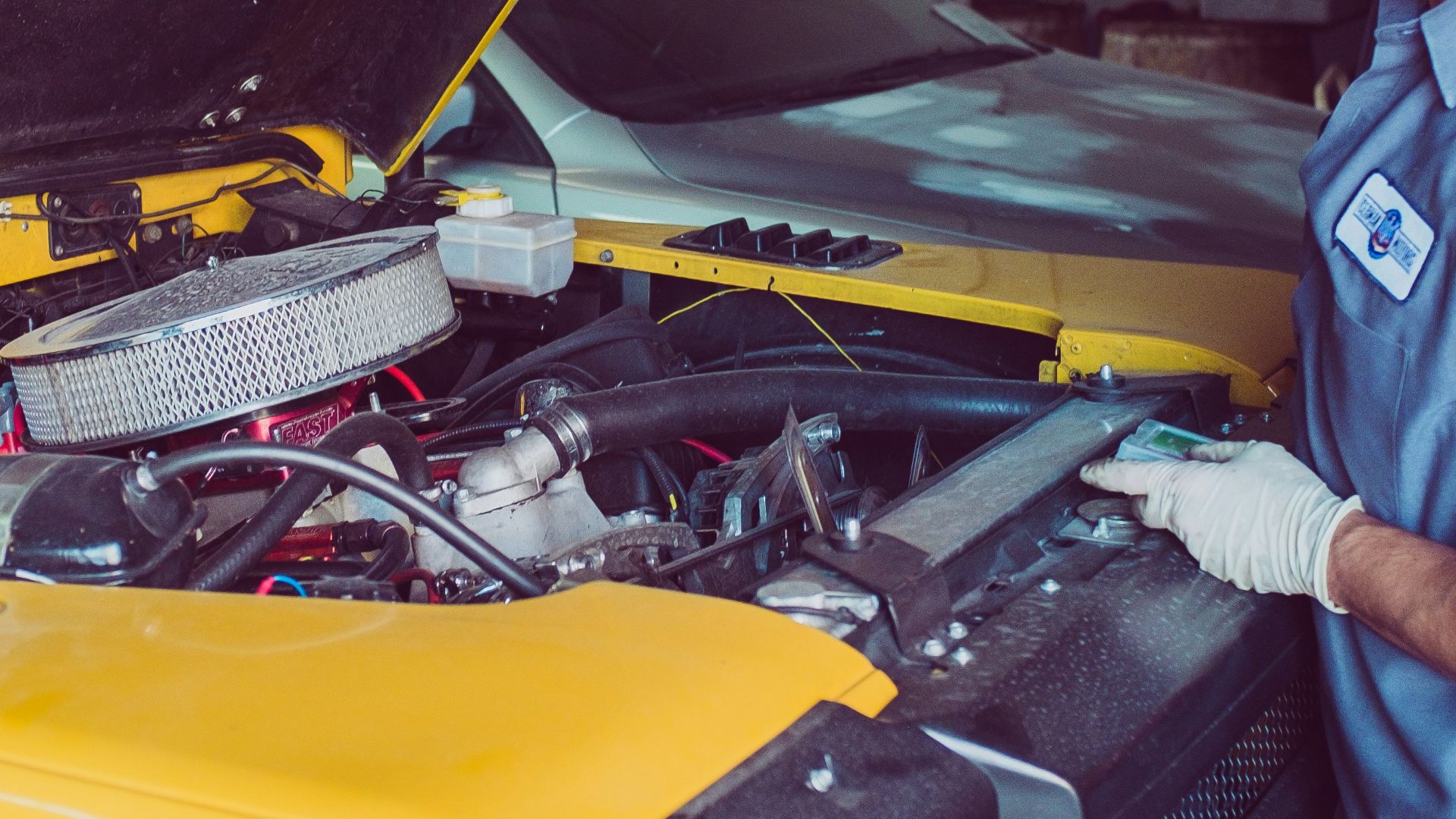 man holding open-wide car trunk