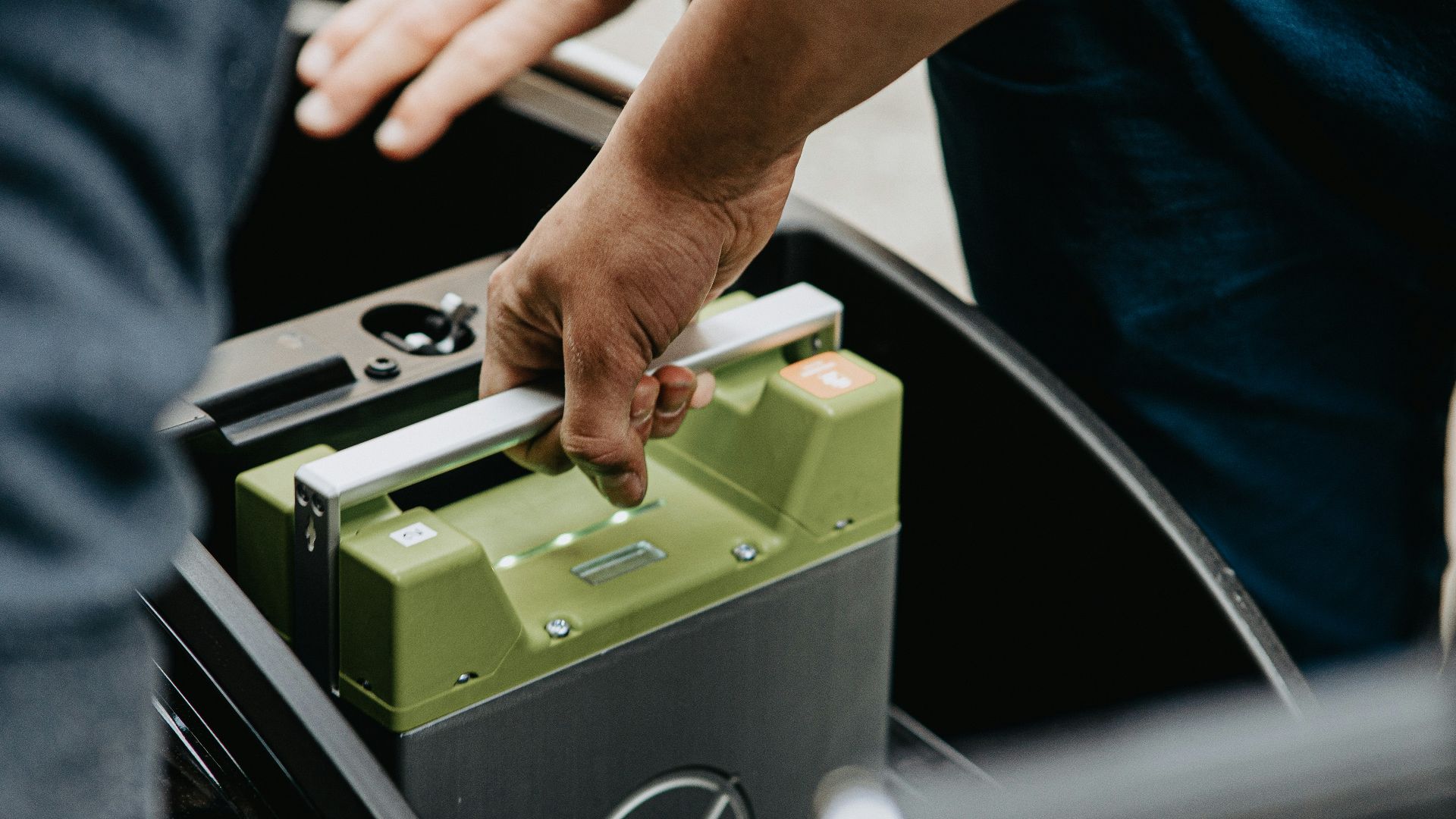 person holding black and green electronic device