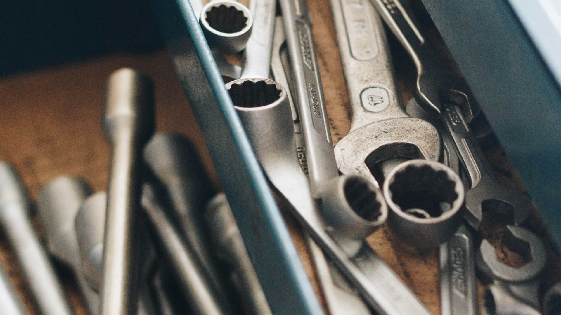 a bunch of wrenches and other tools in a box