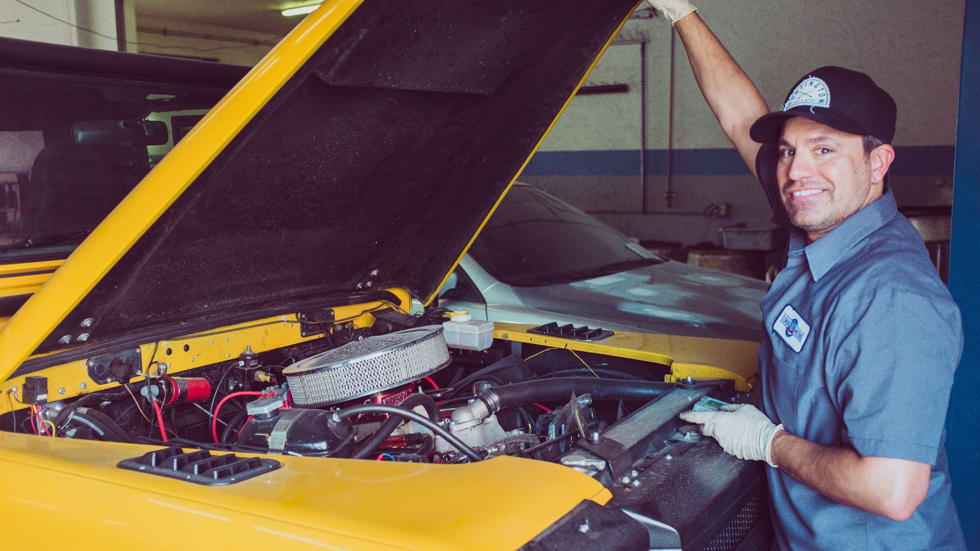 man holding open-wide car trunk
