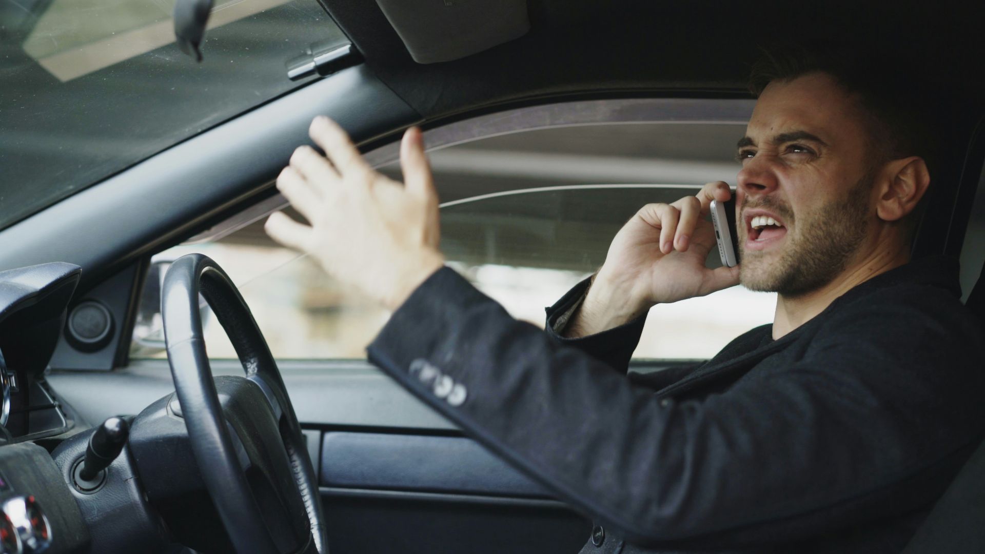 Man talking on phone while driving car