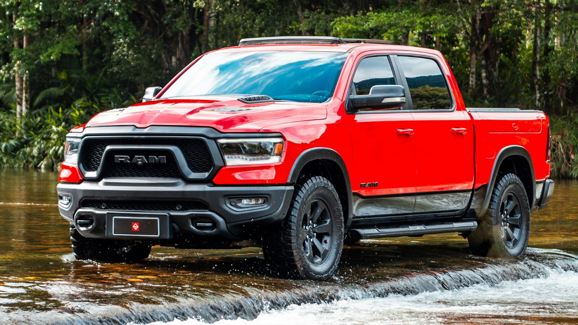 A red truck wades through the water.