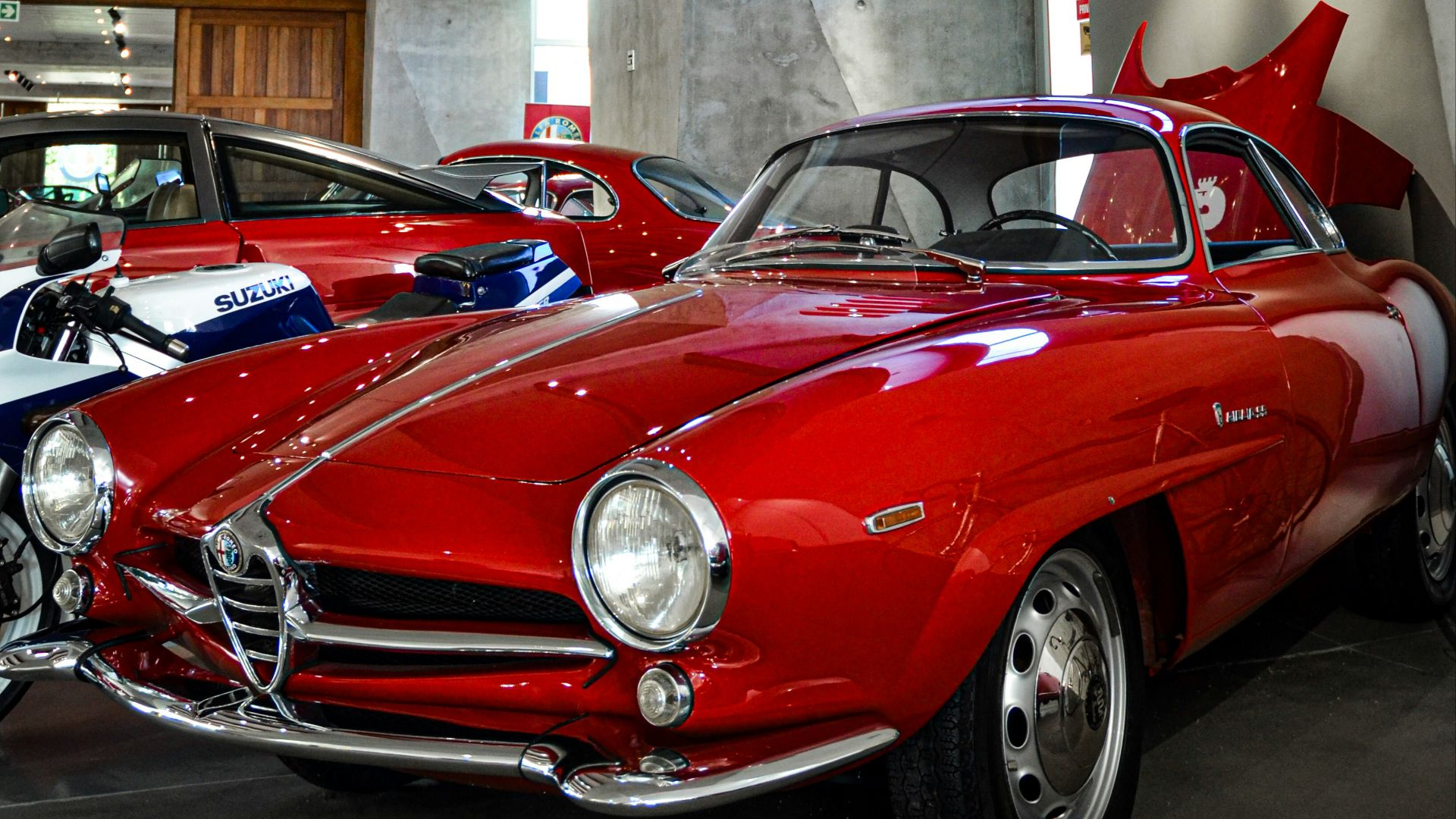 A group of classic cars parked in a garage