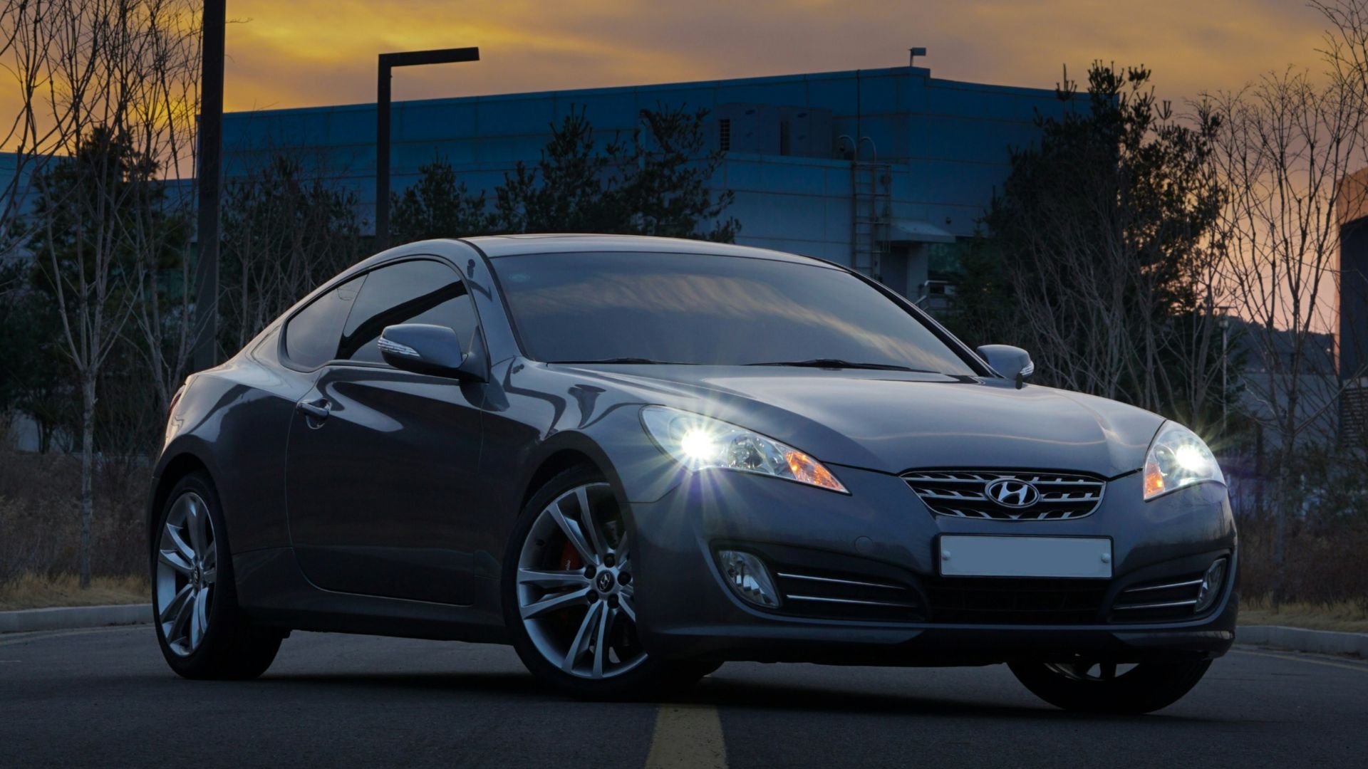 silver porsche 911 parked on parking lot during sunset