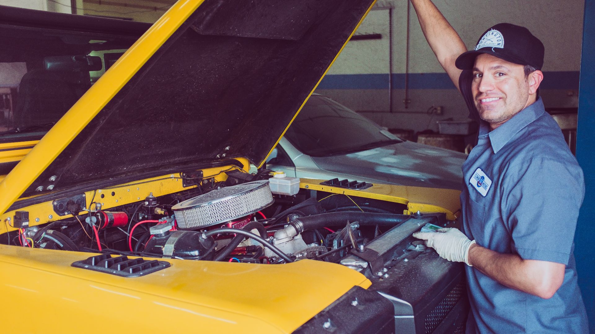 man holding open-wide car trunk