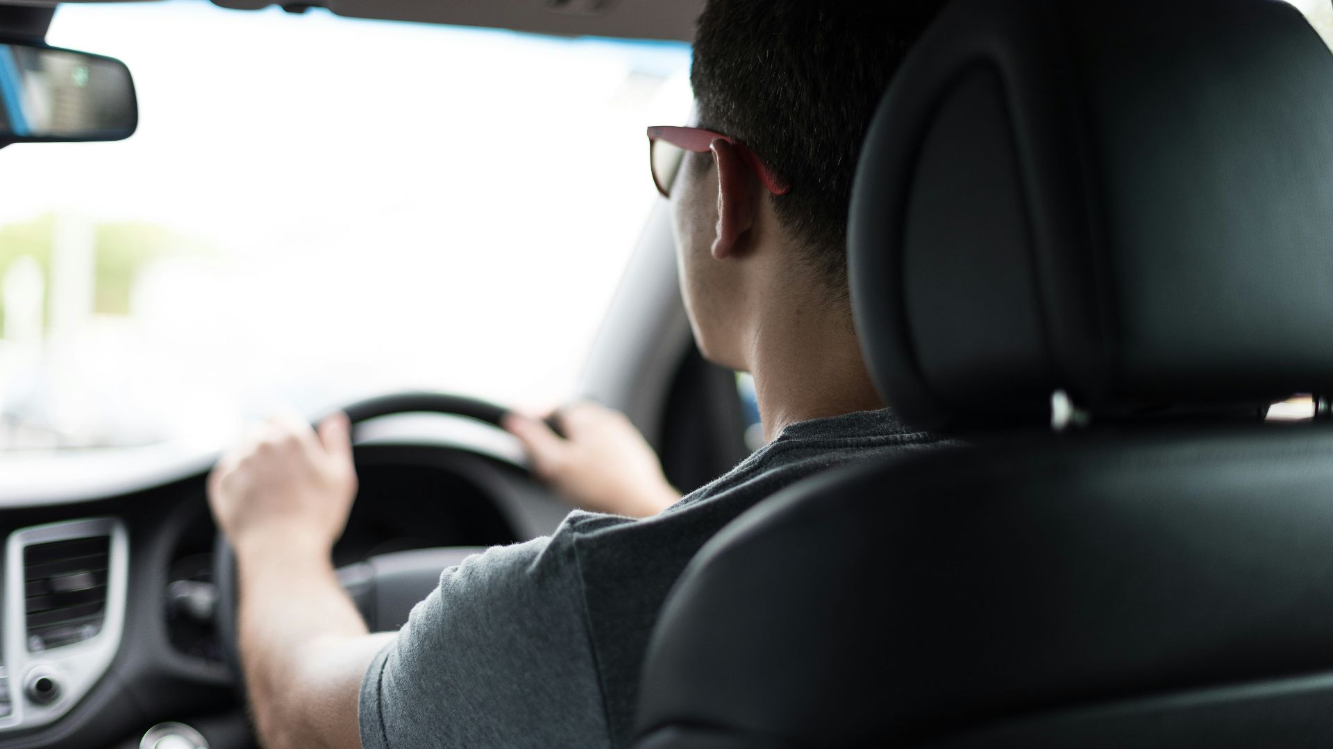 man driving car during daytime
