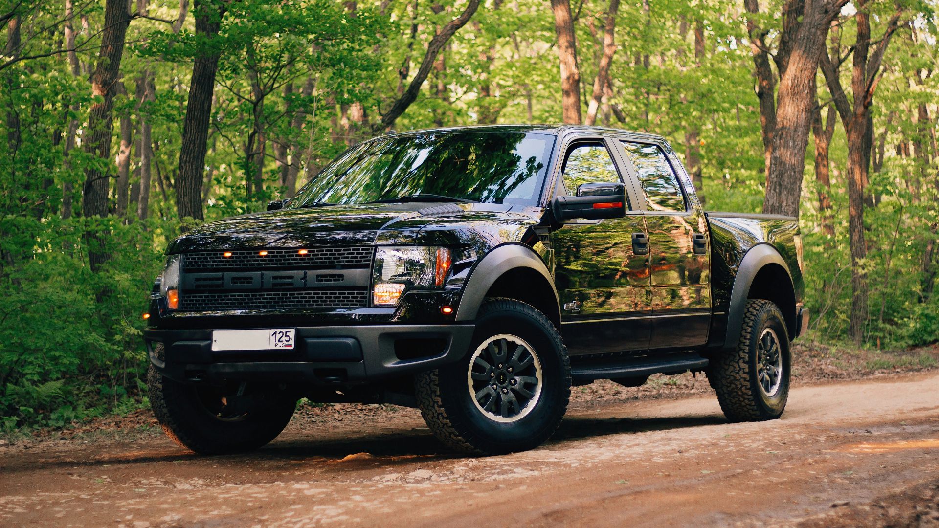 black and yellow chevrolet crew cab pickup truck parked on dirt road during daytime