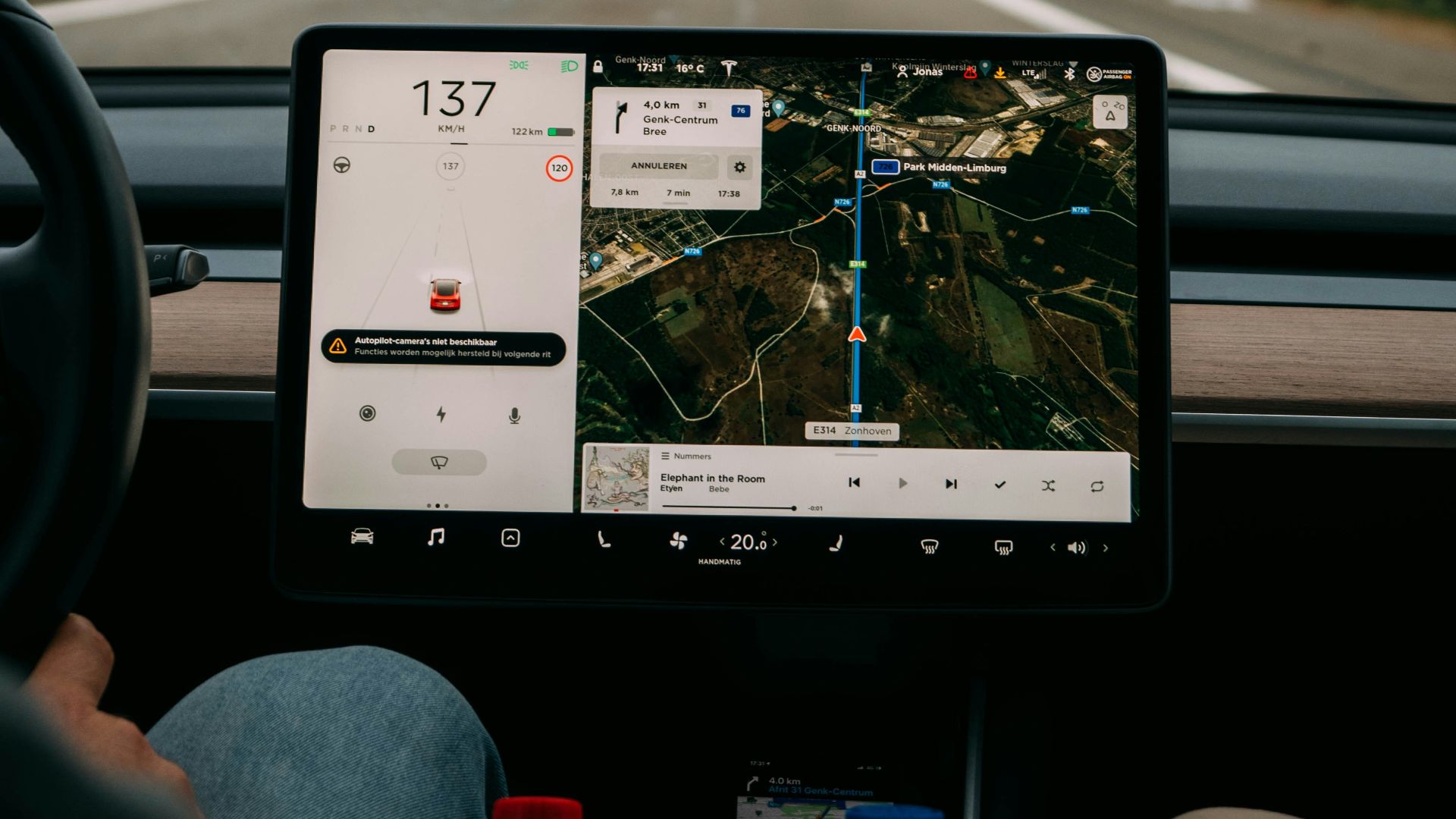 person holding white ipad inside car