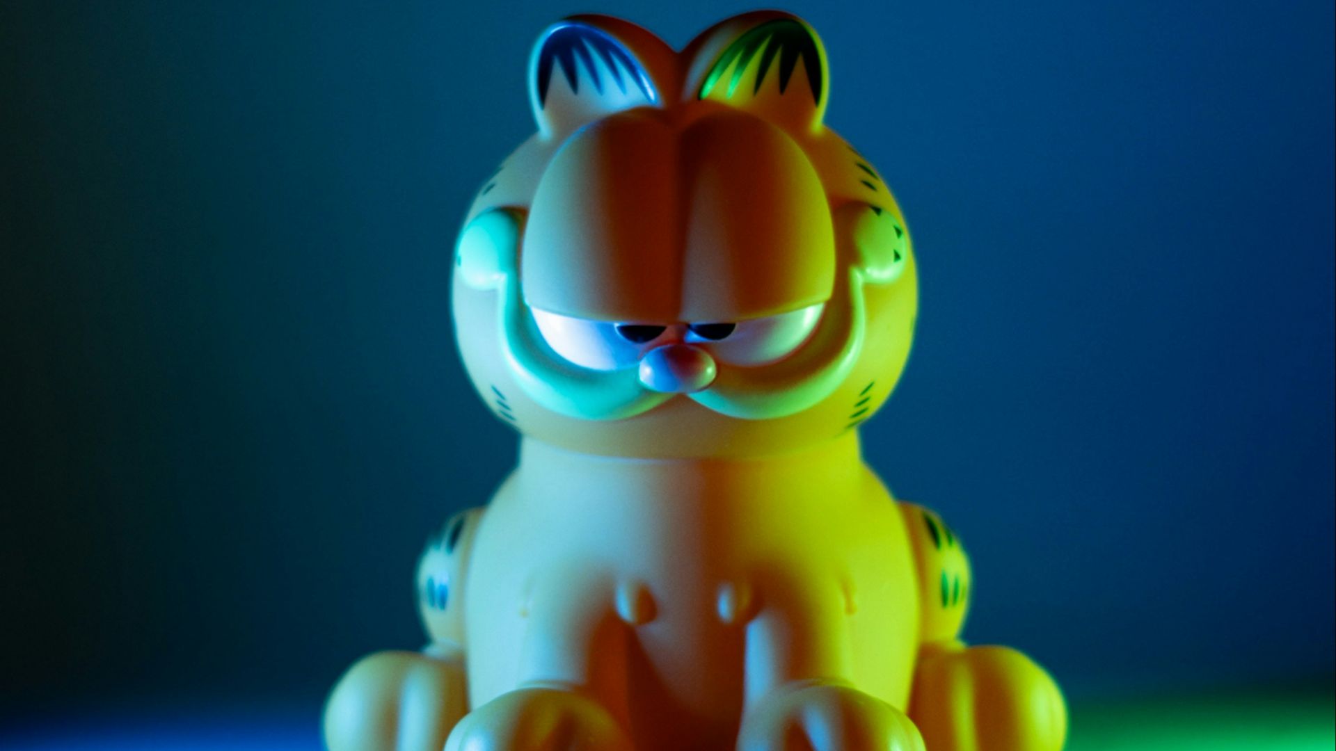 a small toy tiger sitting on a blue surface