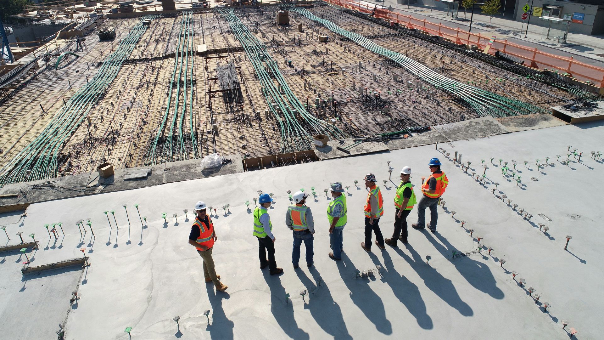seven construction workers standing on white field