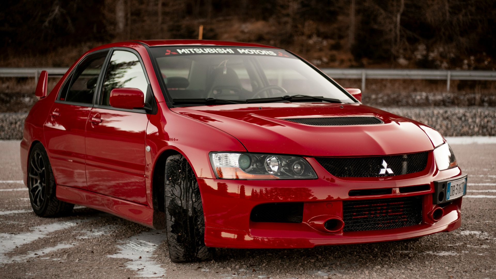 red chevrolet camaro on road during daytime