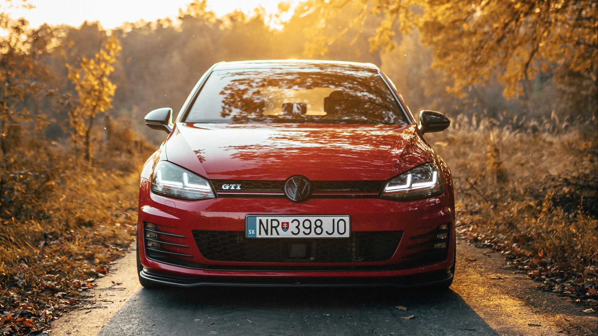 red vehicle beside tree
