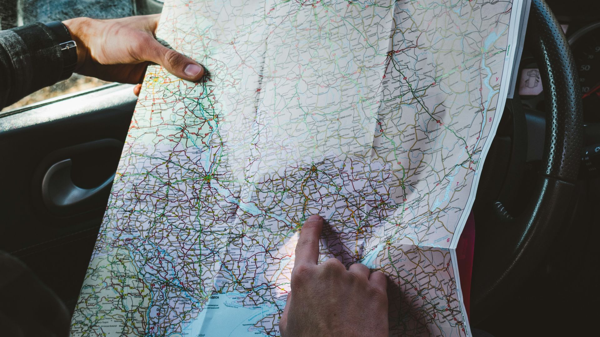 person holding map in vehicle\