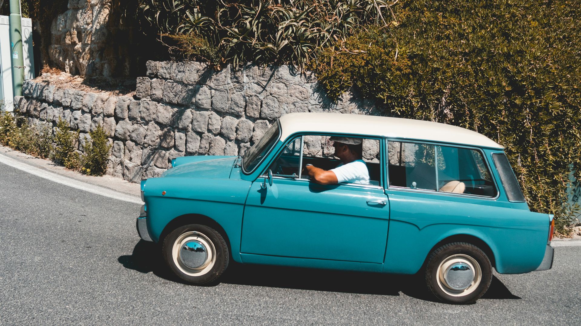 man riding teal vehicle