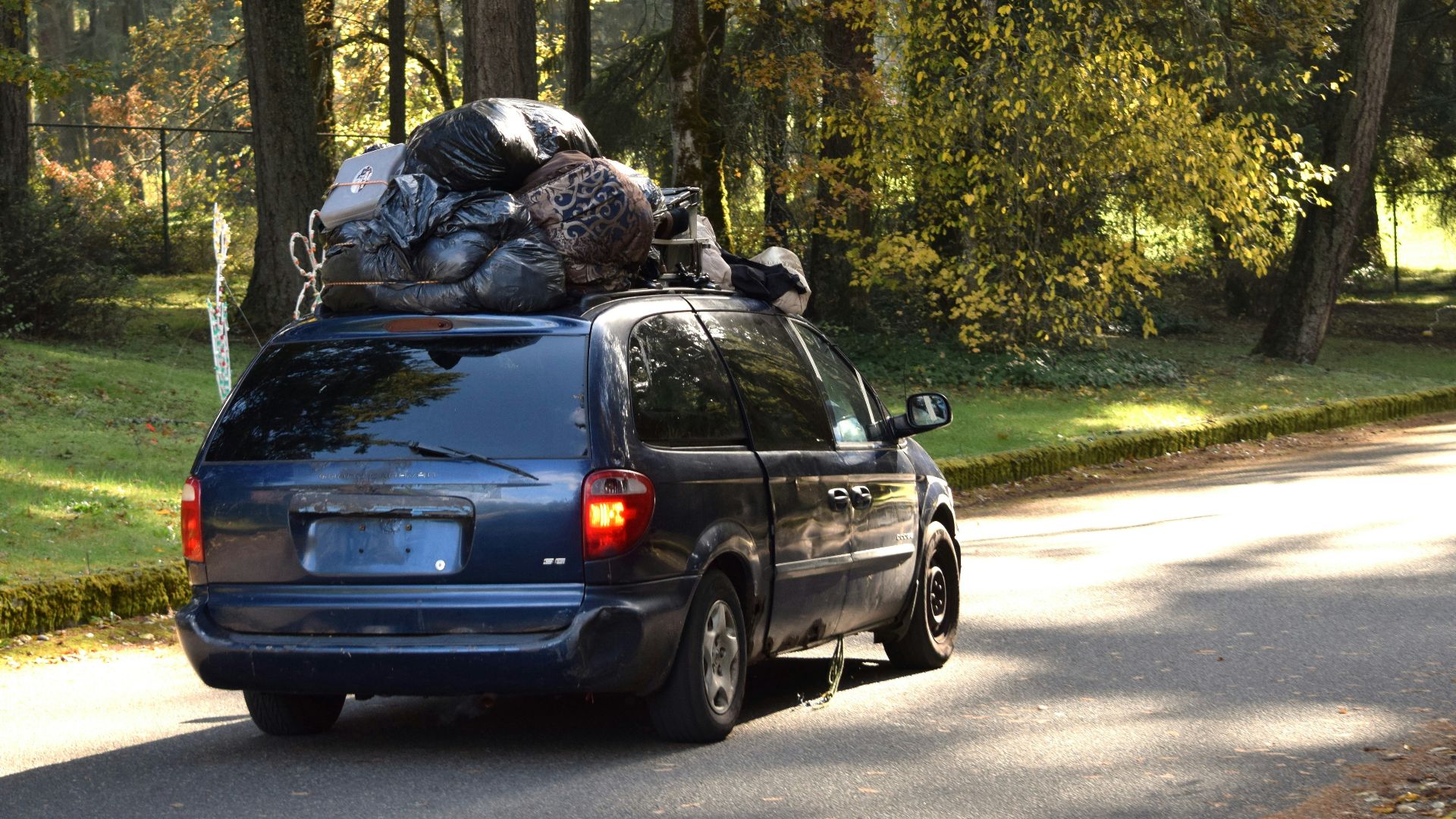 a van with a bunch of luggage on the back of it
