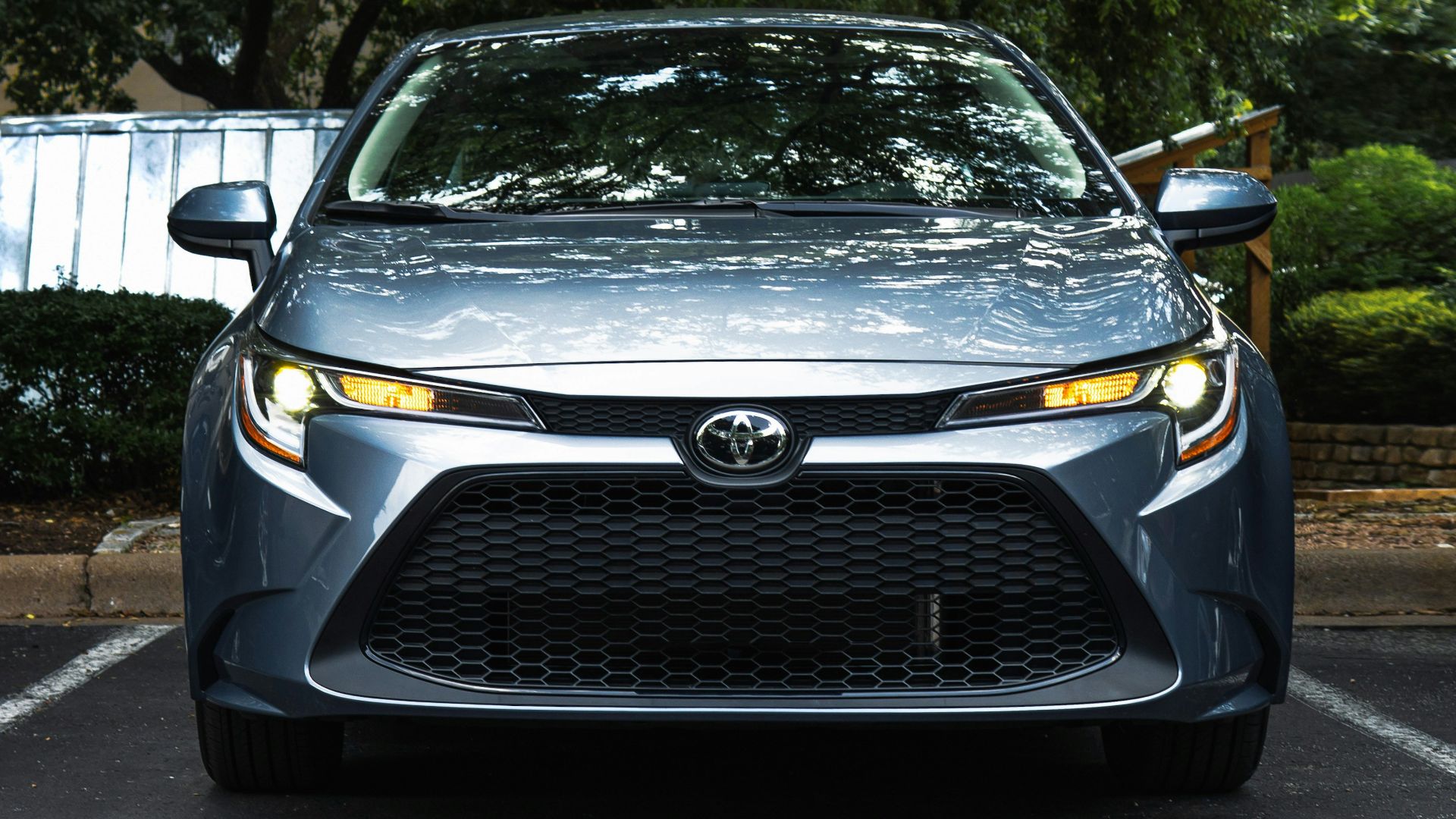 black mercedes benz car parked near green trees during daytime