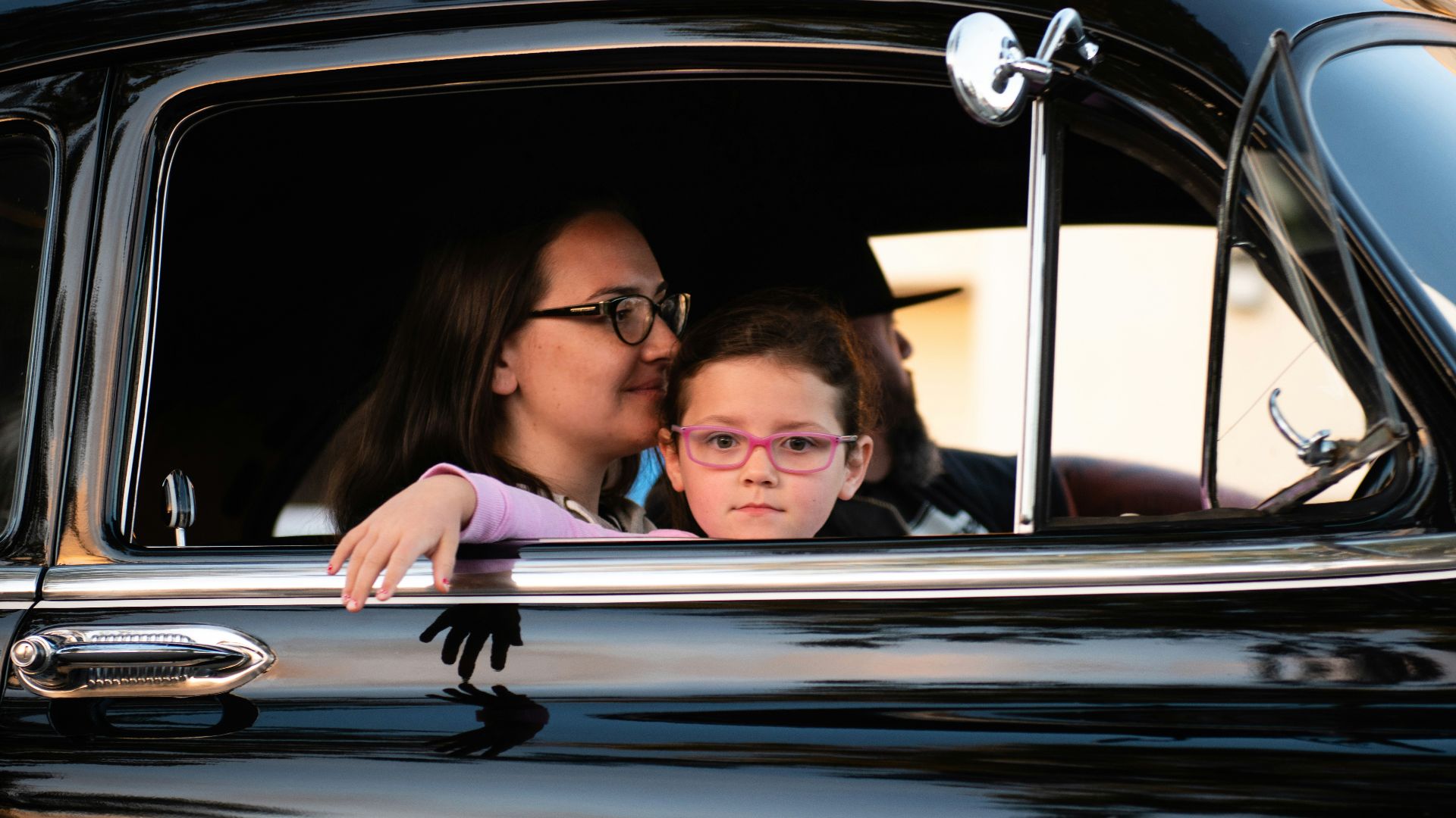 girl and woman inside black car