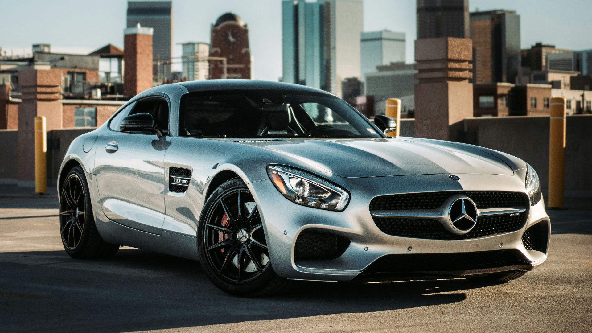 silver mercedes benz coupe parked on gray concrete road during daytime