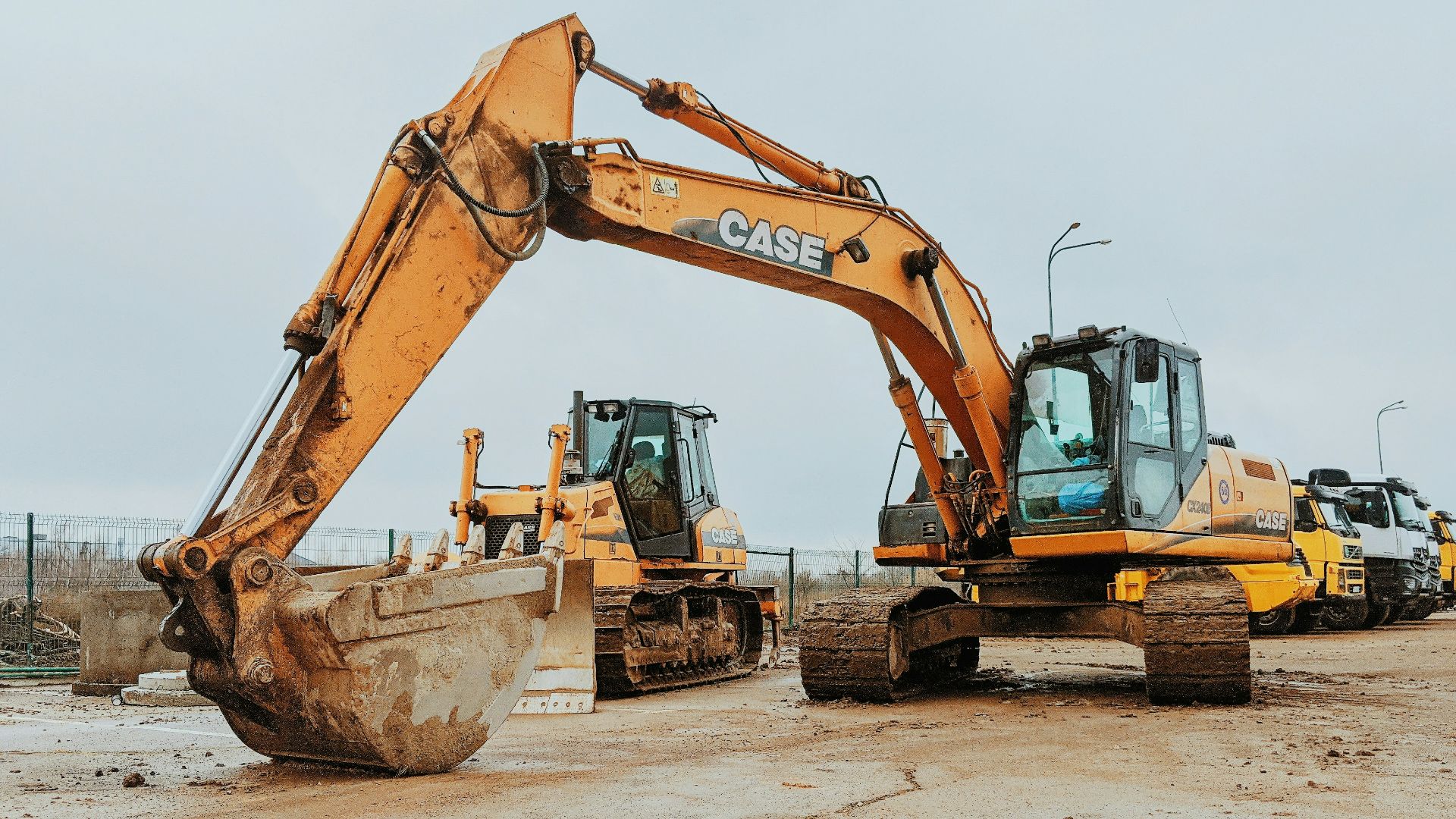 yellow excavator on gray concrete road during daytime