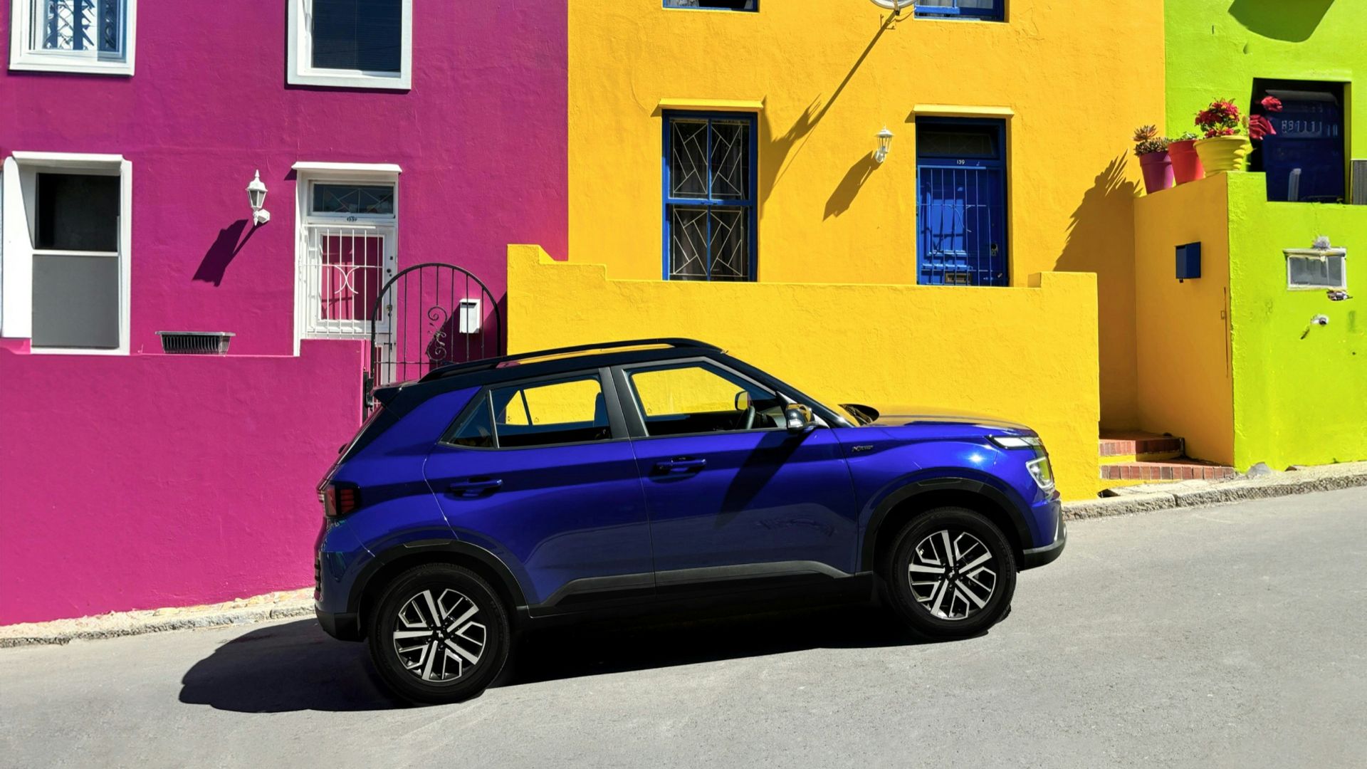 a car parked in front of a multi - colored building