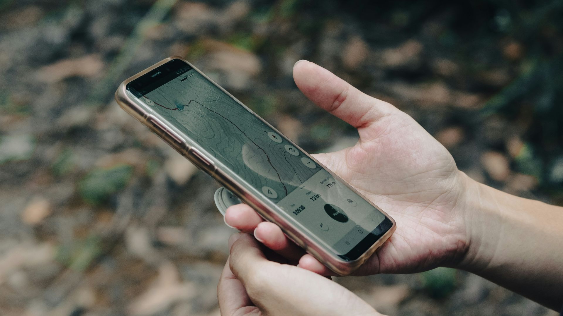 a person holding a cell phone in their hand