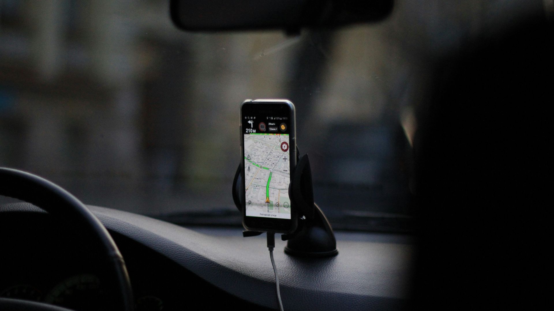 black iphone 4 on car seat