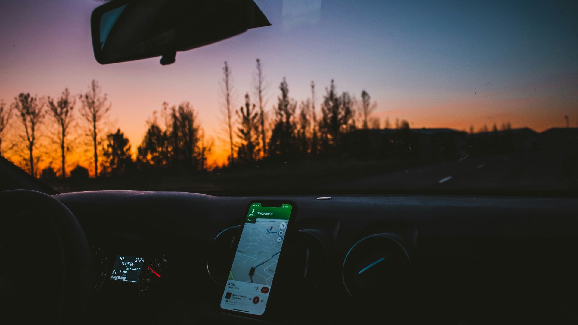 car on road during sunset