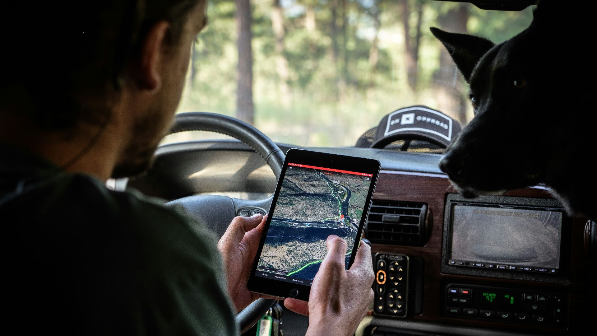 man in gray shirt holding black tablet computer