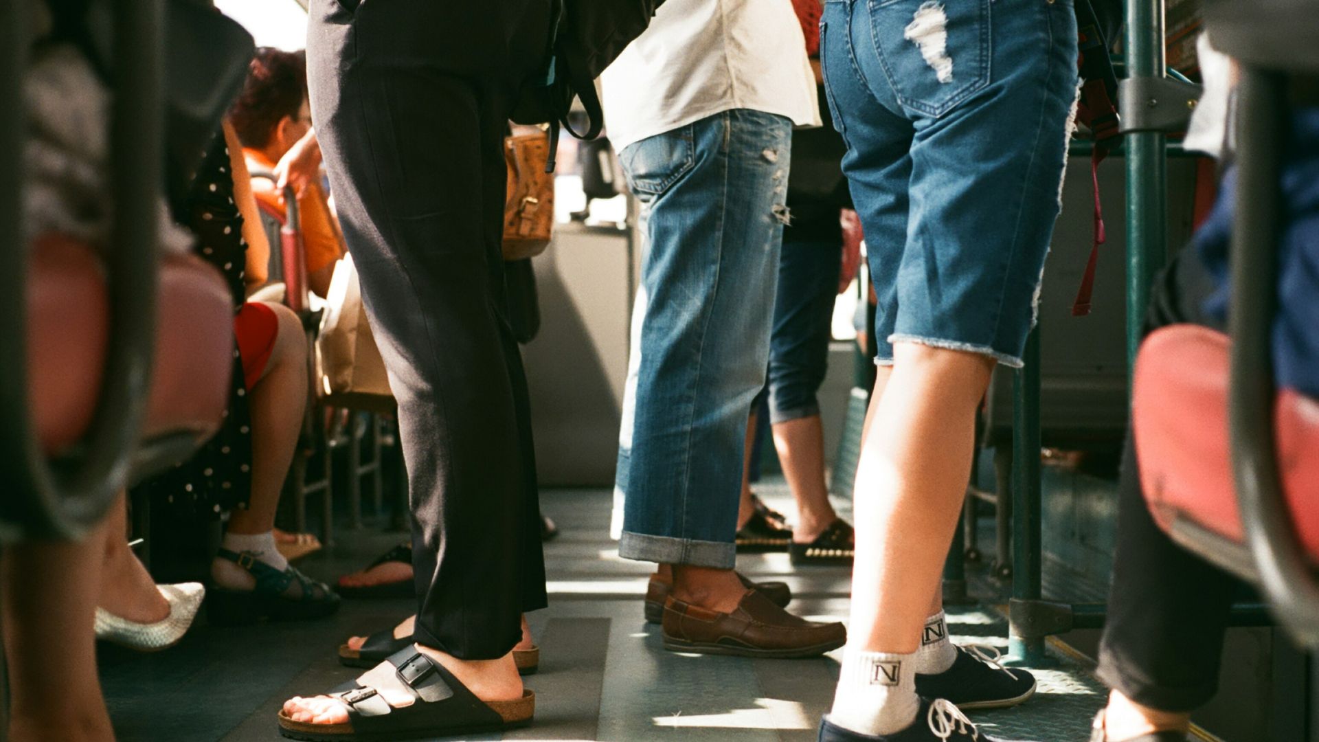 group of person sitting and standing inside the vehicle