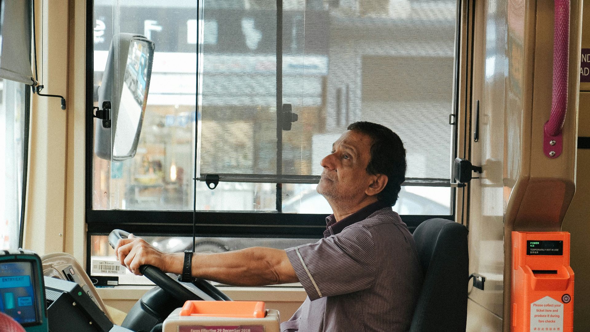 man in brown and white plaid button up shirt sitting on black office rolling chair