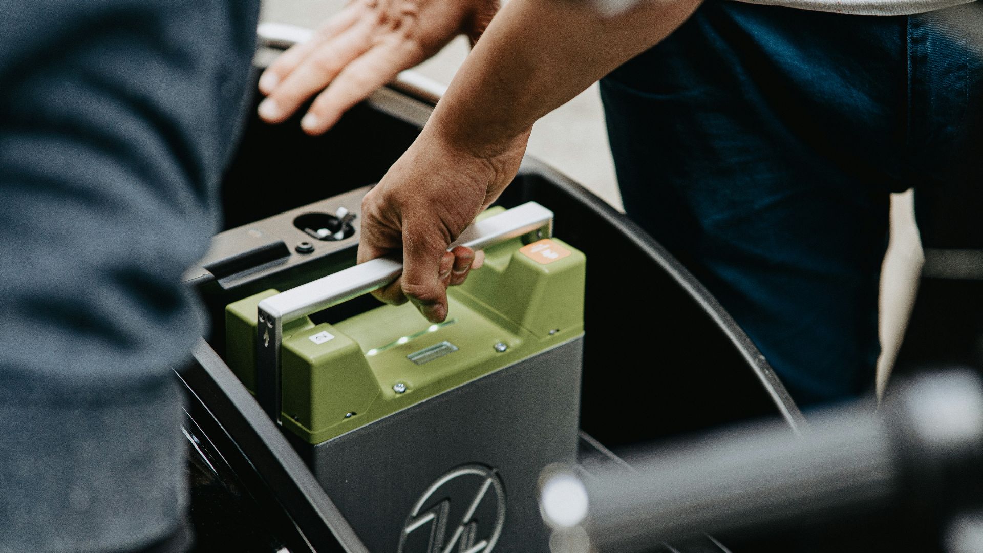 person holding black and green electronic device